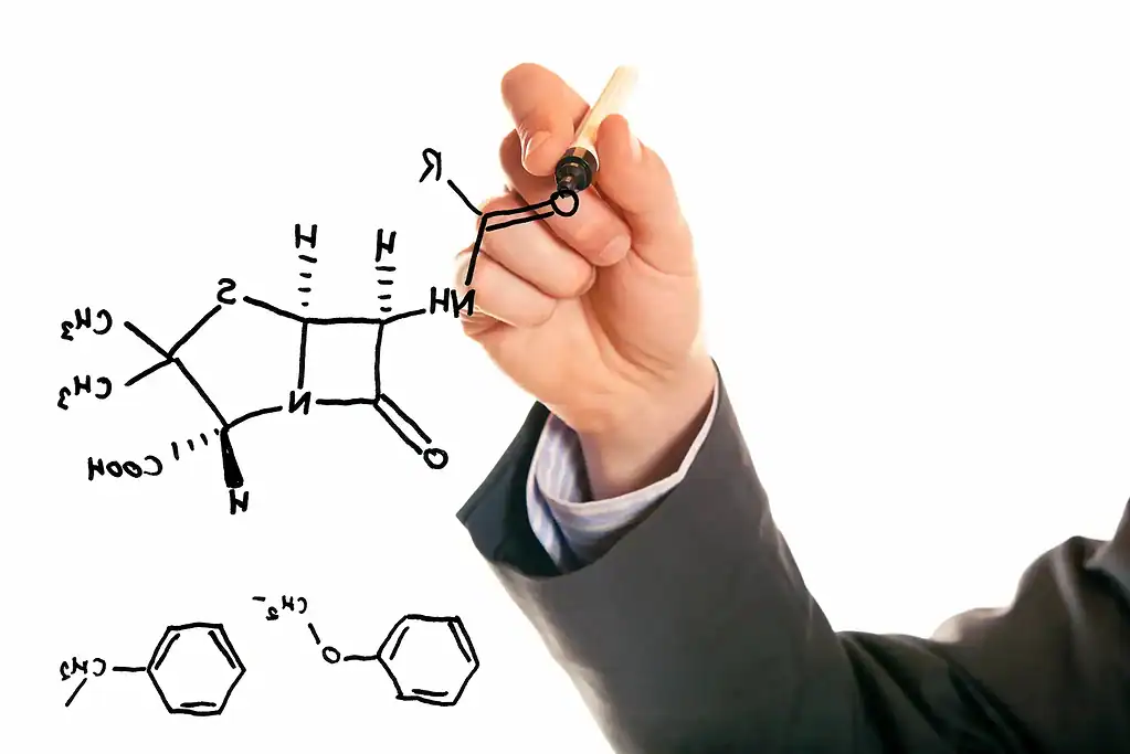 A hand drawing science sketches in black dry erase marker.