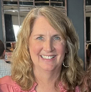 Professional businesswoman smiling at corporate event for CTLG consulting services.