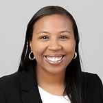 Professional woman smiling in business attire, representing CTLG Consulting services.