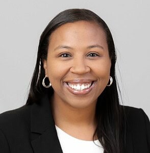 Professional woman smiling in business attire, representing CTLG Consulting services.