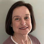 Confident woman smiling, professional corporate headshot for business and consulting services.