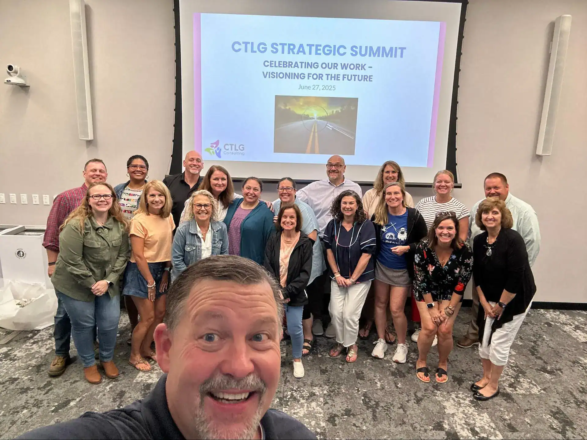 Diverse team at CTLG Consulting's strategic summit, celebrating teamwork and future vision, June 27, 2025.