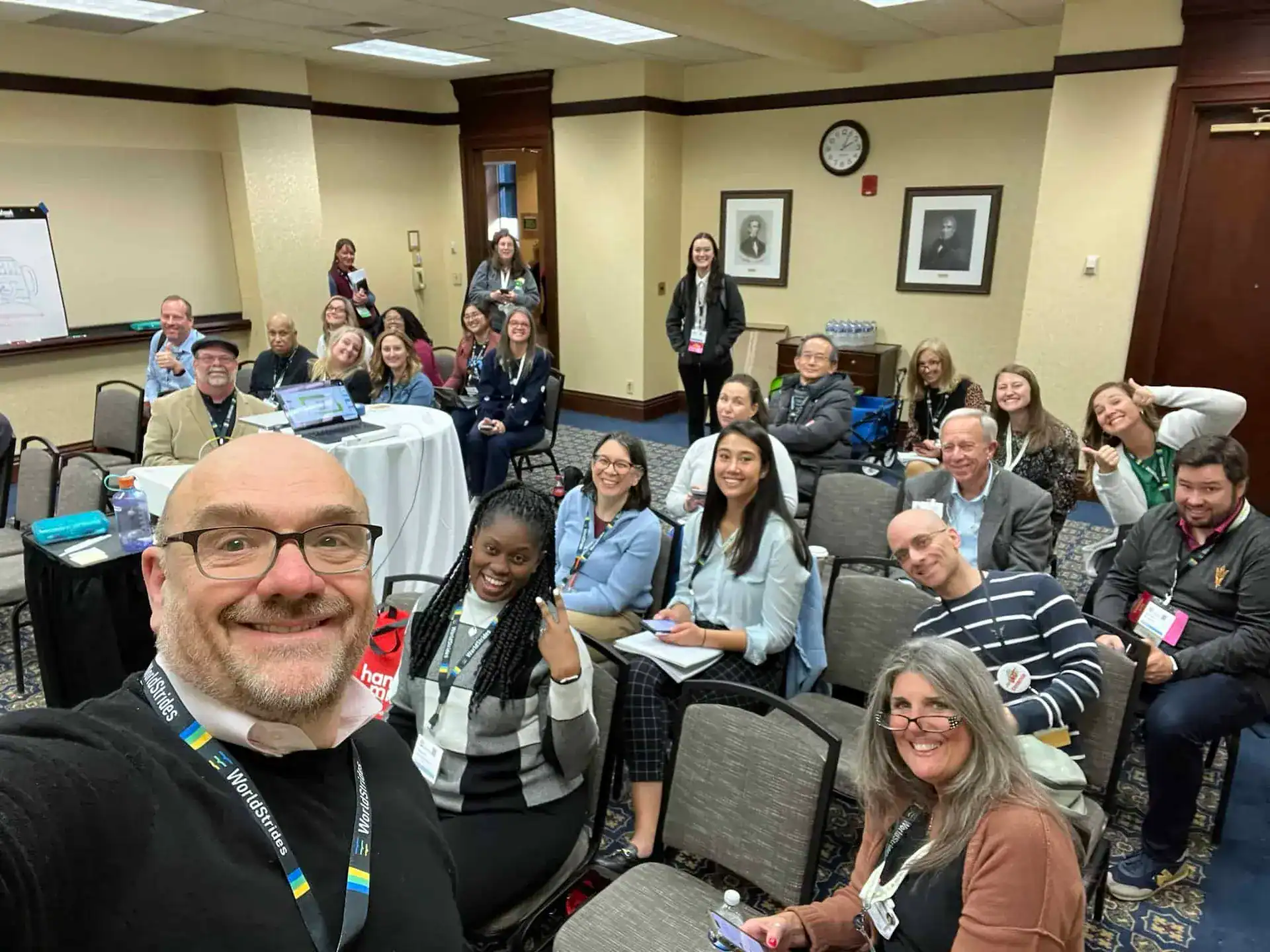 Diverse group of professionals attending a conference or workshop at CTLG, smiling and engaging in networking activities.