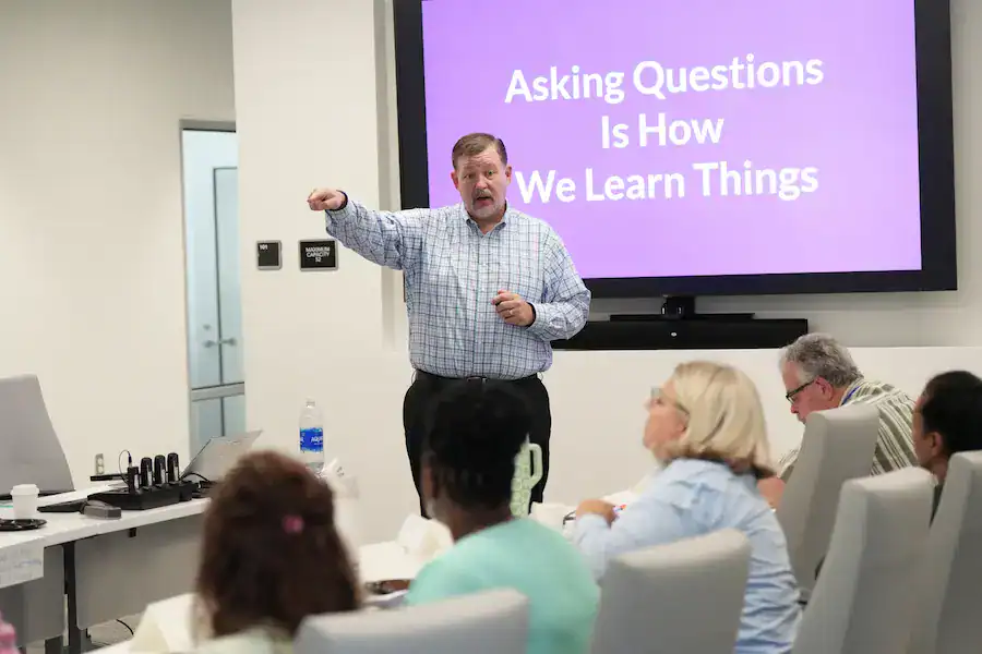 Engaged business leader delivering a presentation on effective learning strategies in a corporate training session.